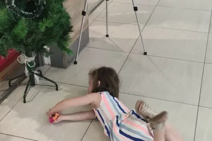 Kid lying on the floor in a shop