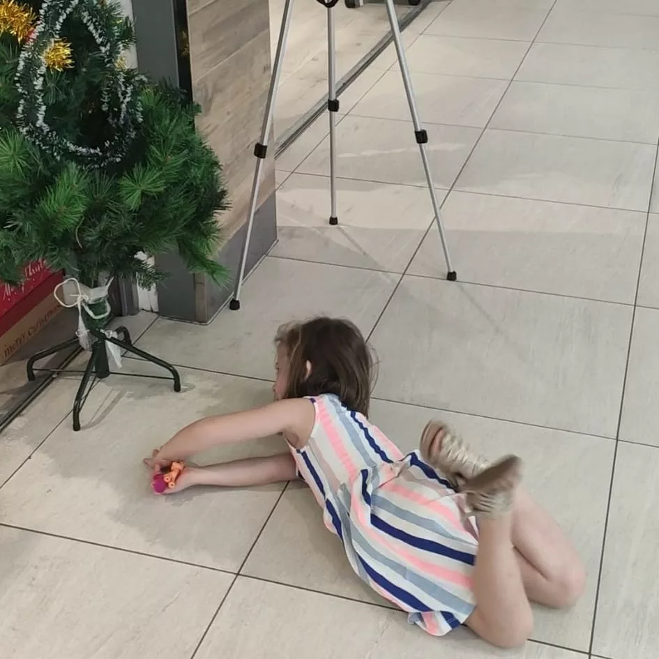 Kid lying on the floor in a shop